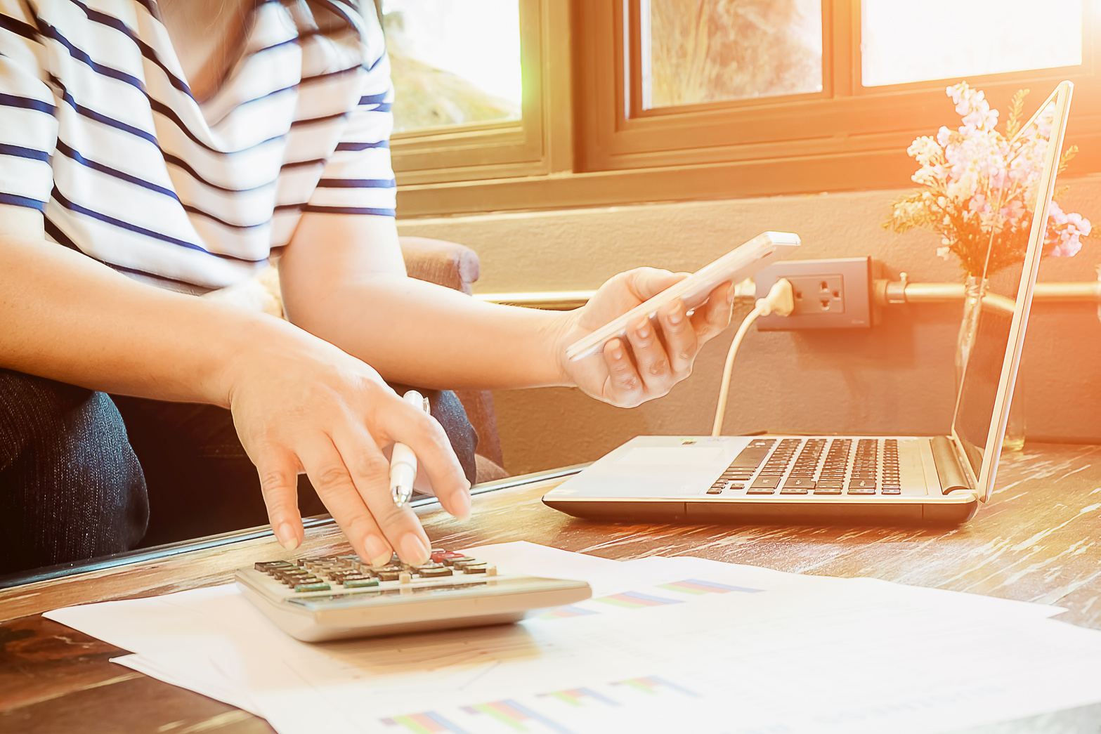 Business Using Smartphone on Table with Laptop Computer